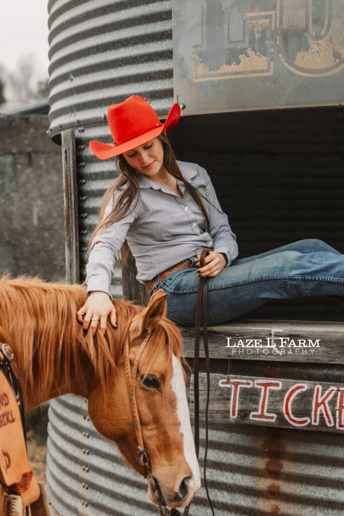 cowgirl petting her horse