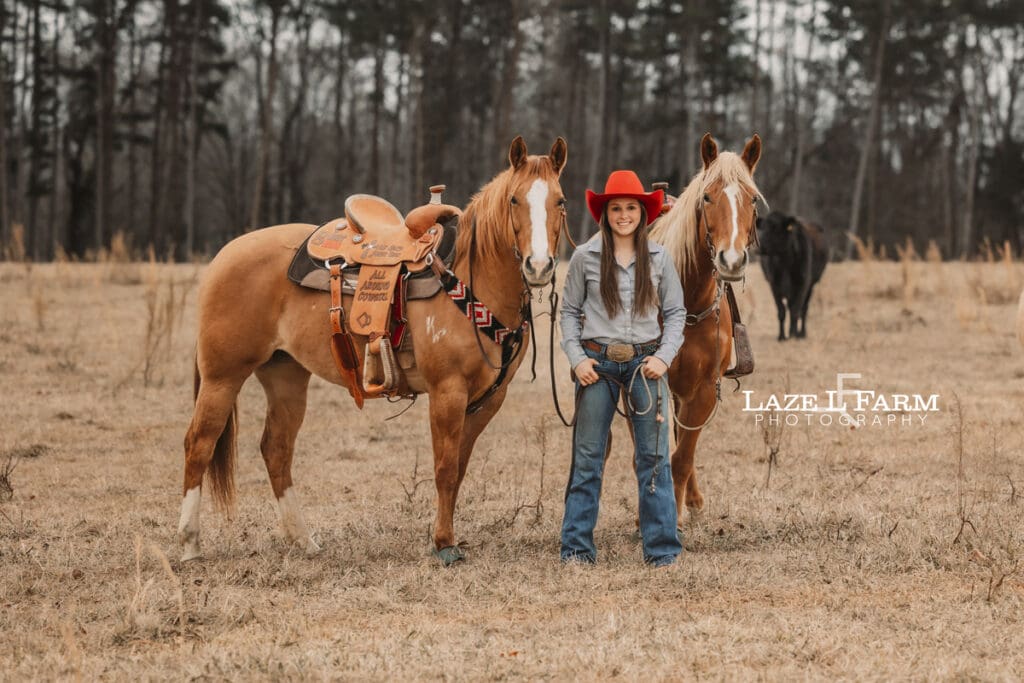 cowgirl standing with her two horses