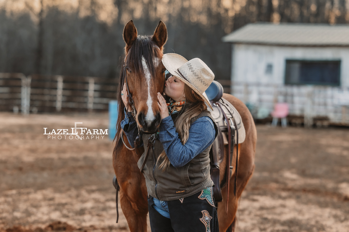 cowgirl kissing her horse