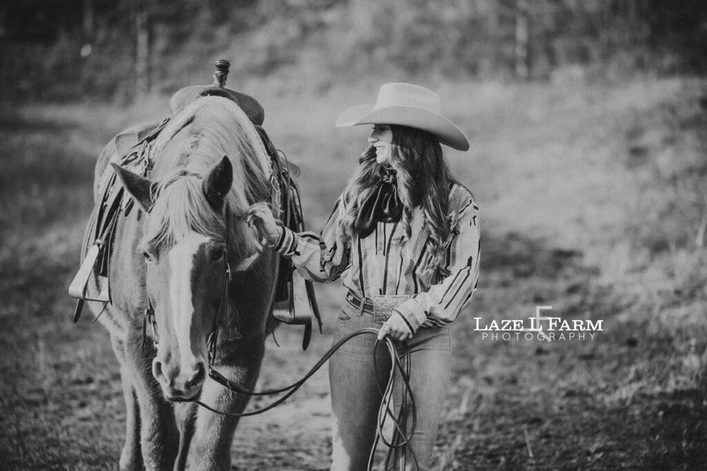 cowgirl walking beside of a horse