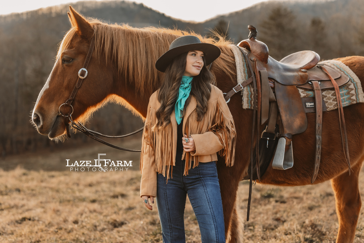 cowgirl standing in front of horse
