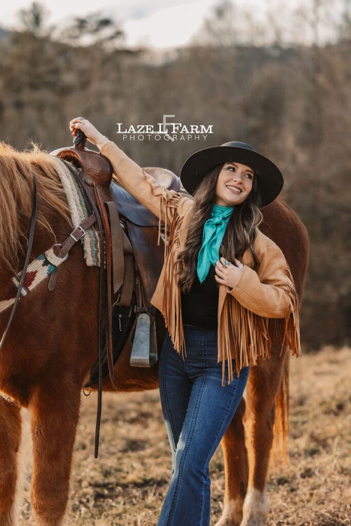 cowgirl standing beside of horse