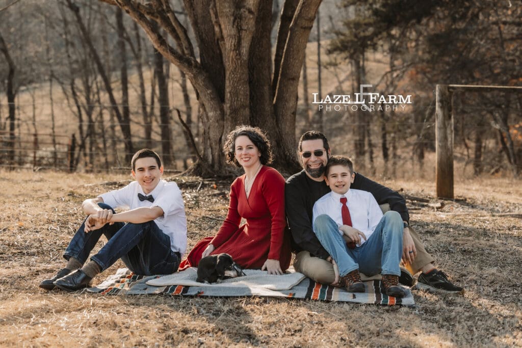 family sitting on a blanket