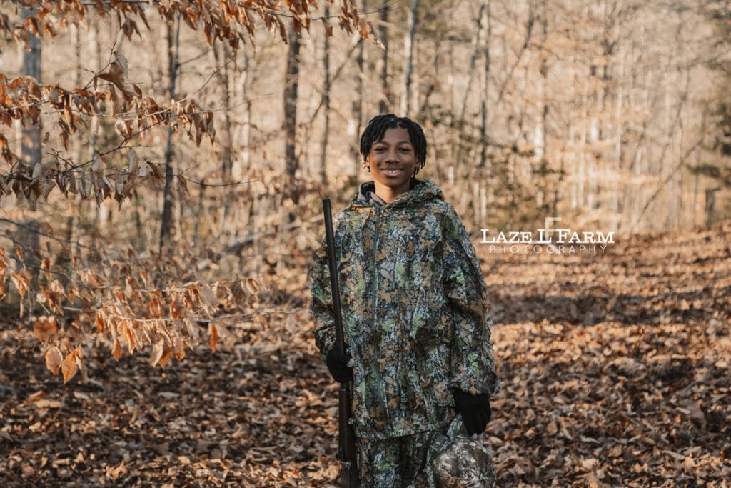 boy standing in the woods