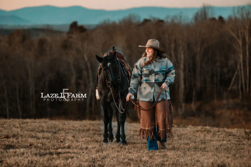 cowgirl walking beside her horse