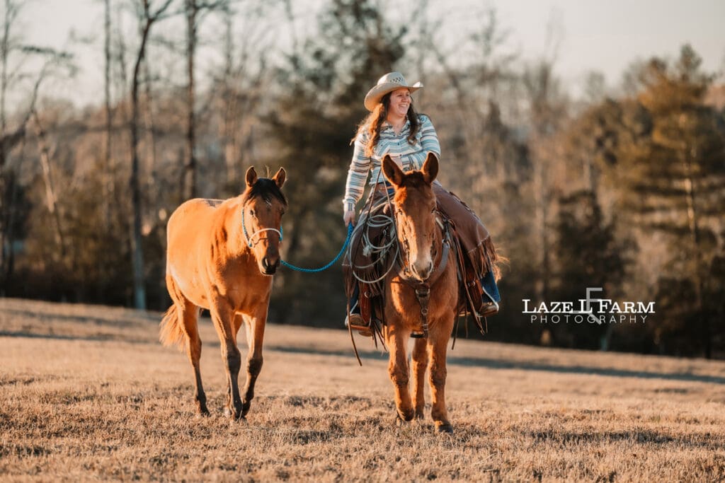 cowgirl riding a mule and leading a colt