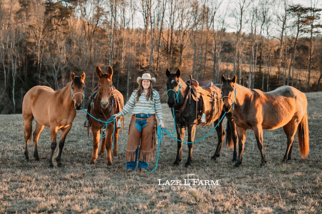 cowgirl with all of her horses