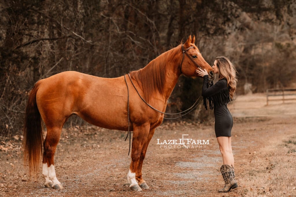 girl kissing her horse on a nose