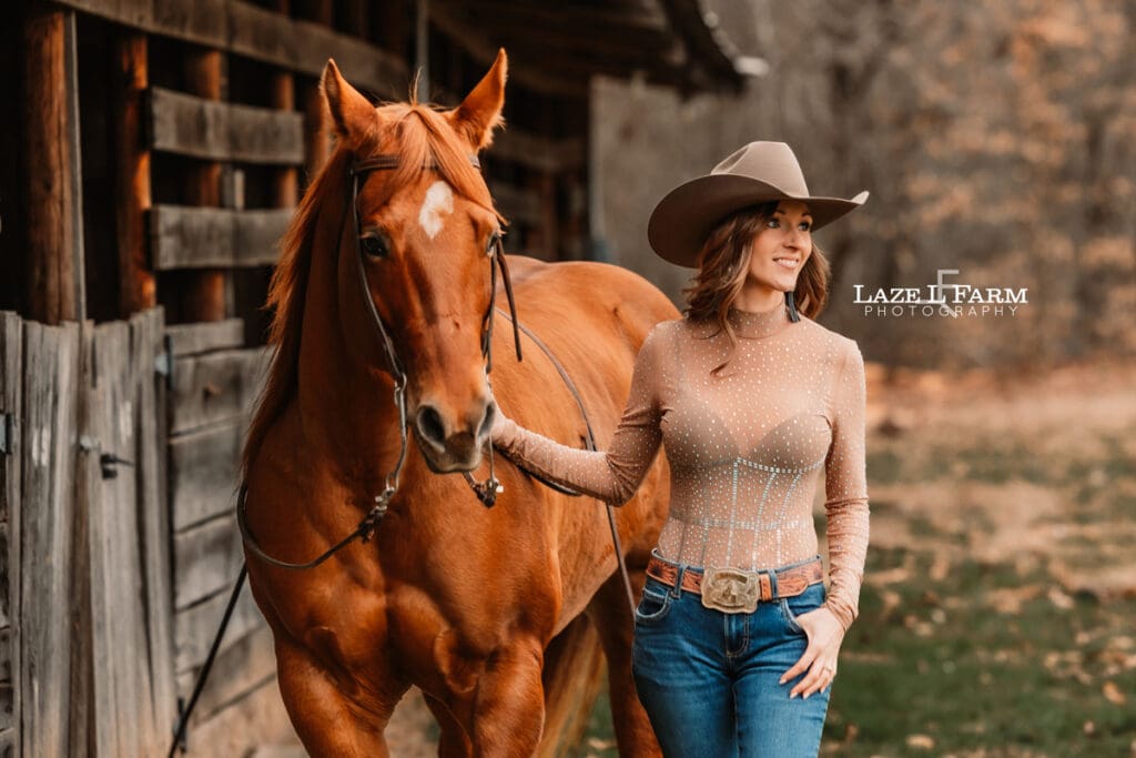 cowgirl standing beside horse