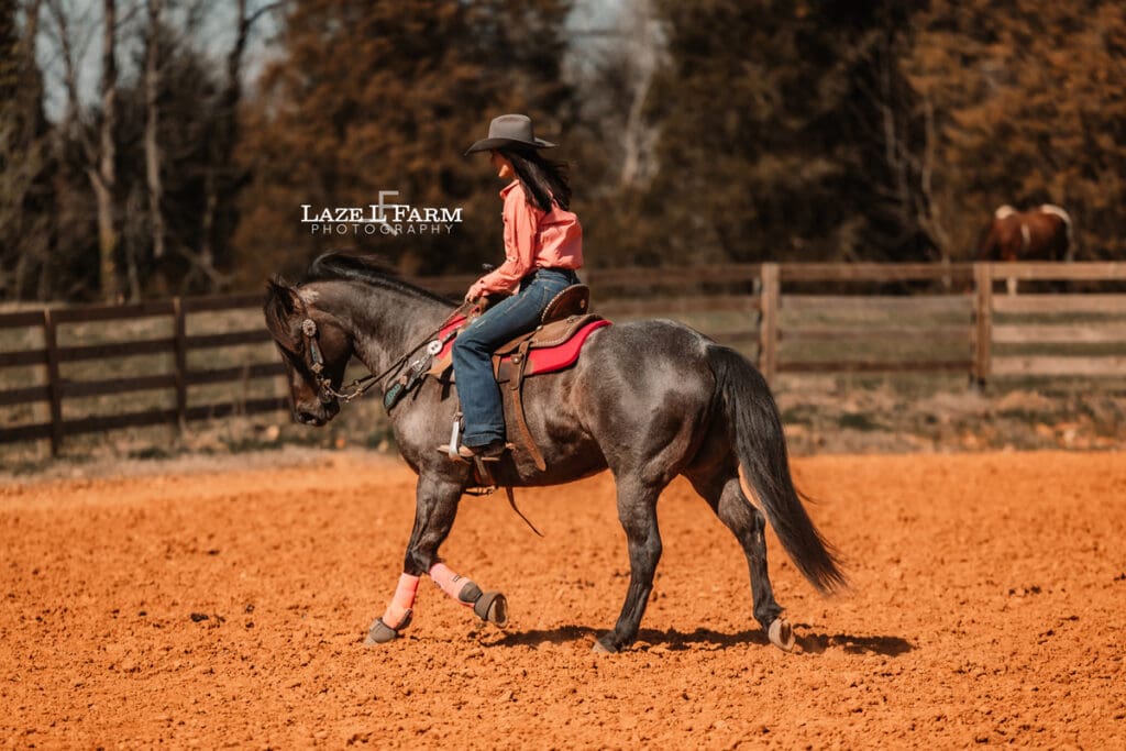 cowgirl riding her horse
