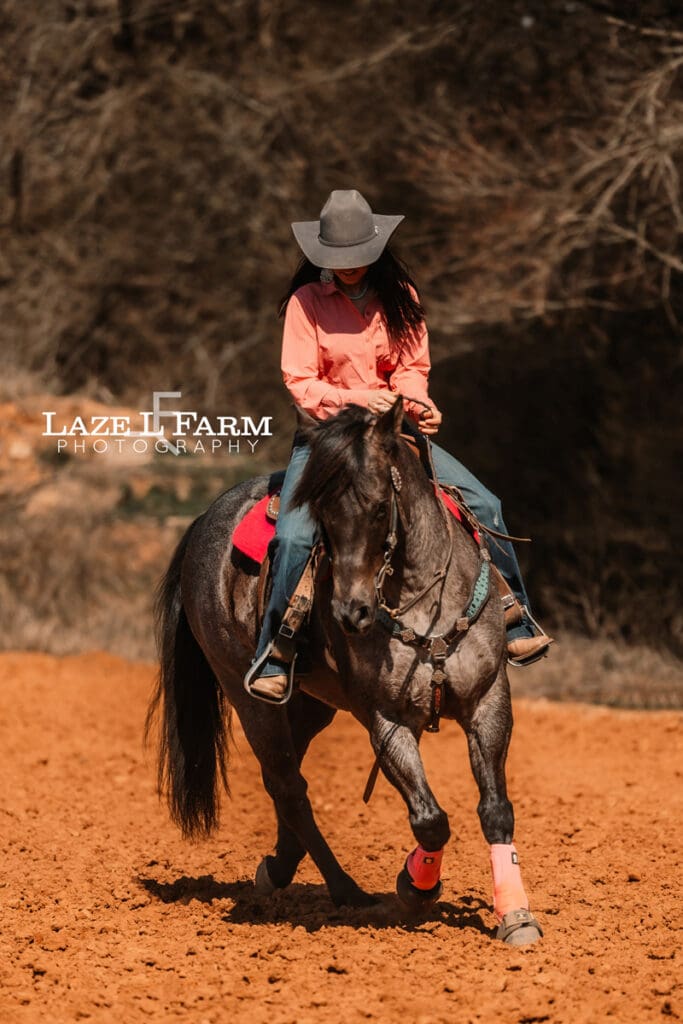 cowgirl riding her horse
