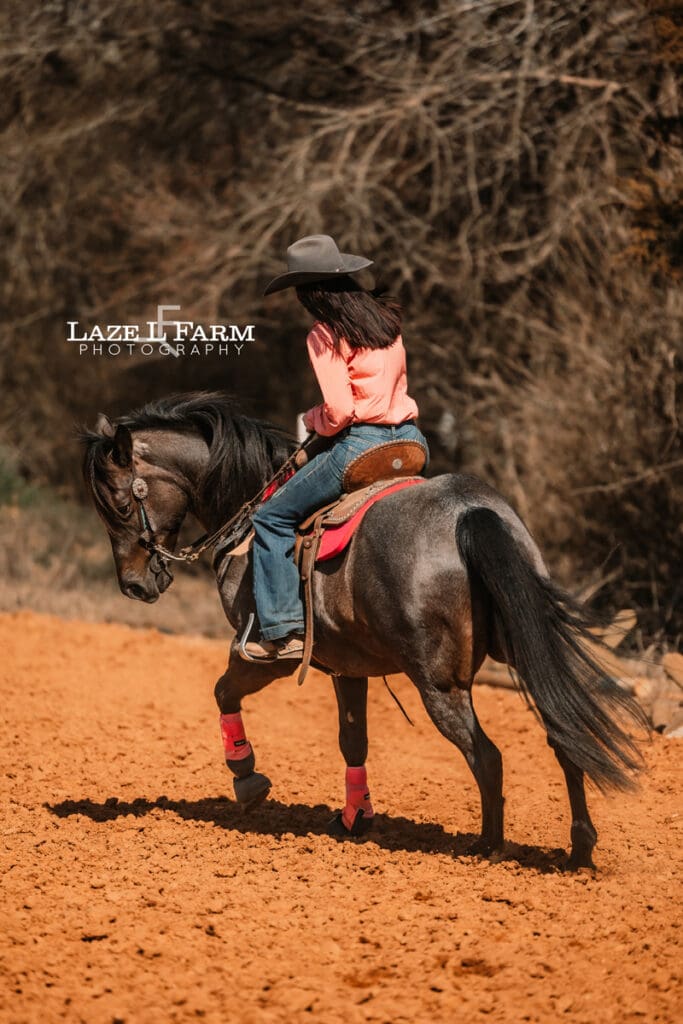 cowgirl riding her horse