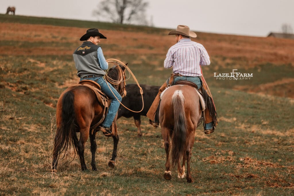 cowboys riding their horse