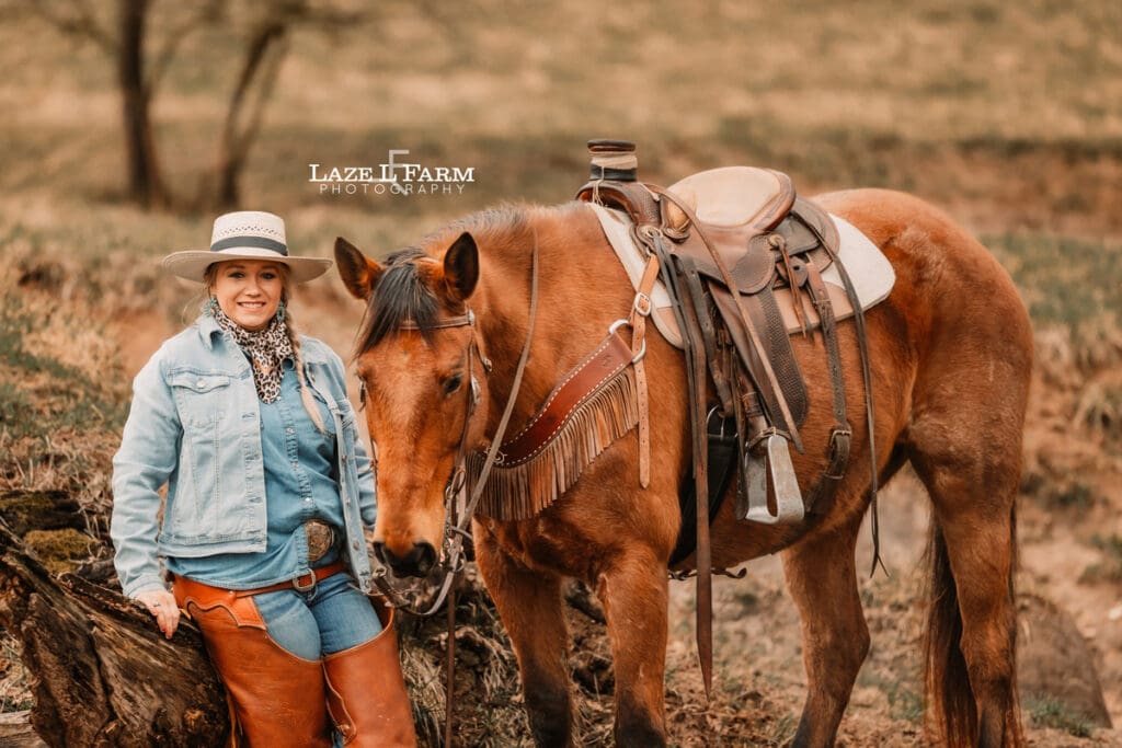 cowgirl with her horse in the creek