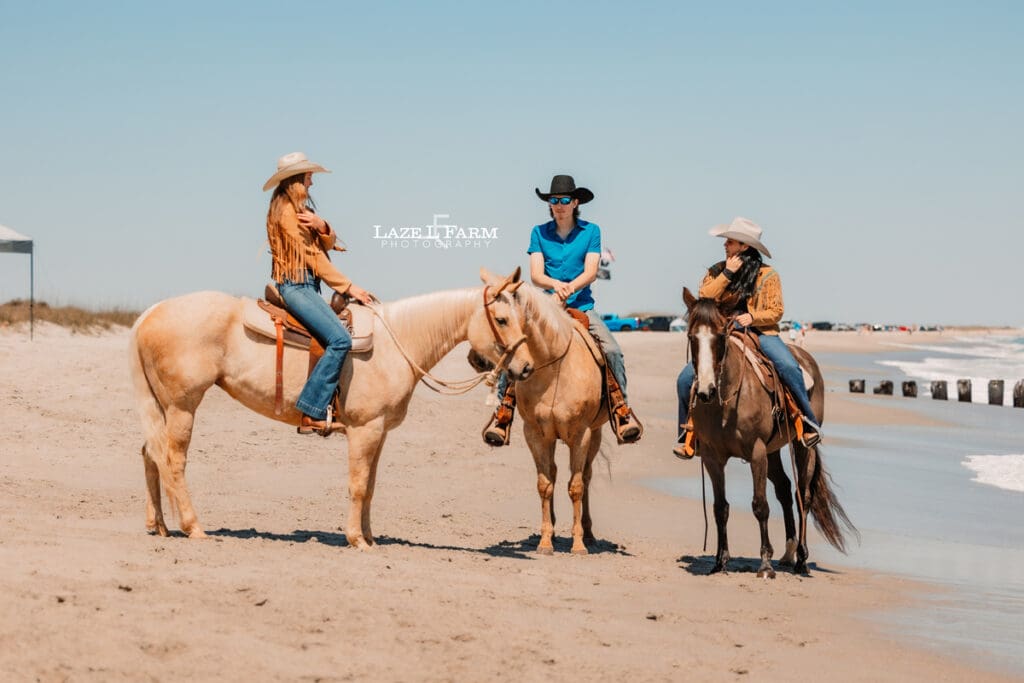 cowgirls and horses on the beach