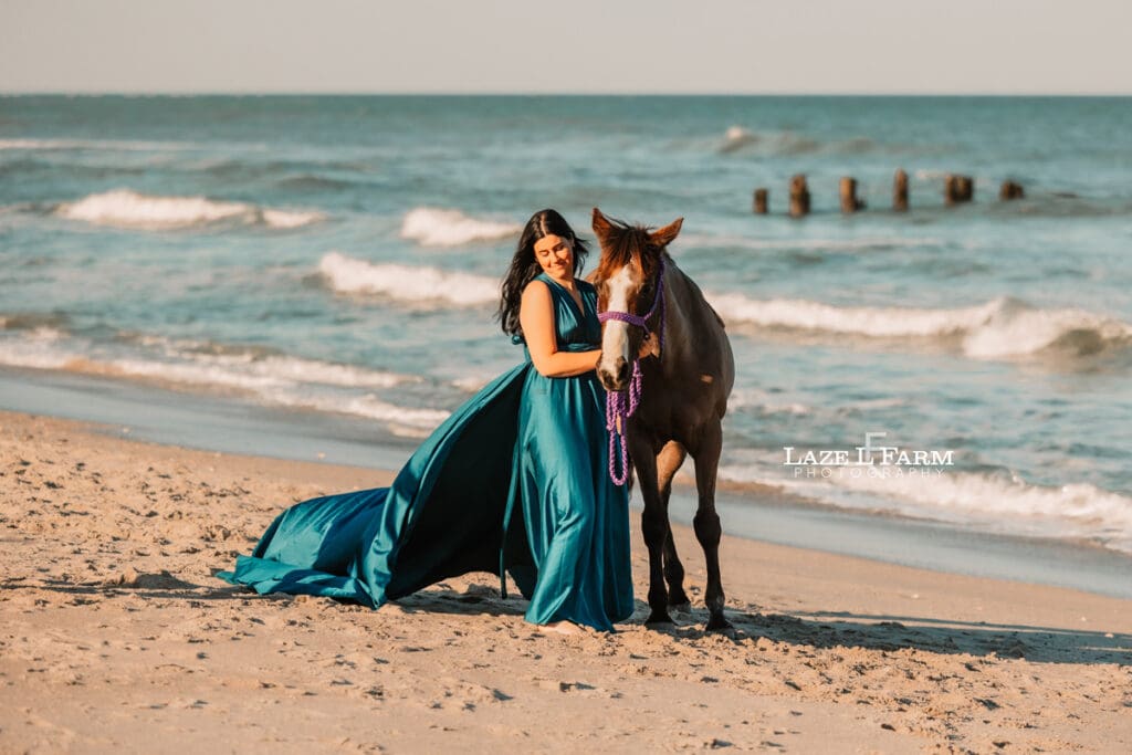 cowgirl on the beach with her horse in a flying dress