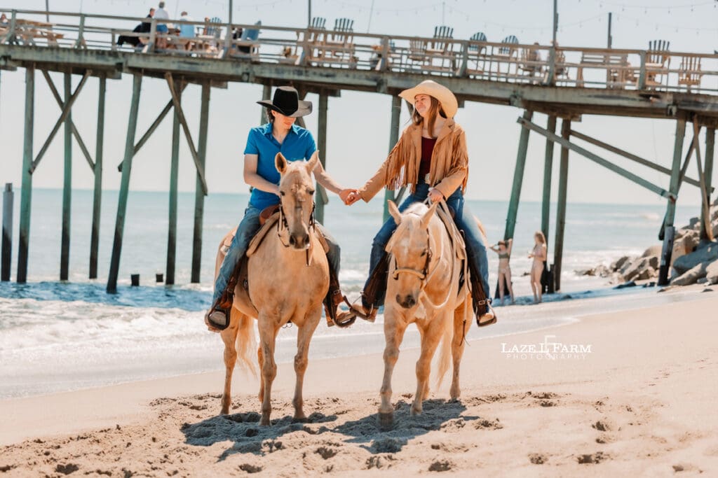 Couple riding horses on the beach