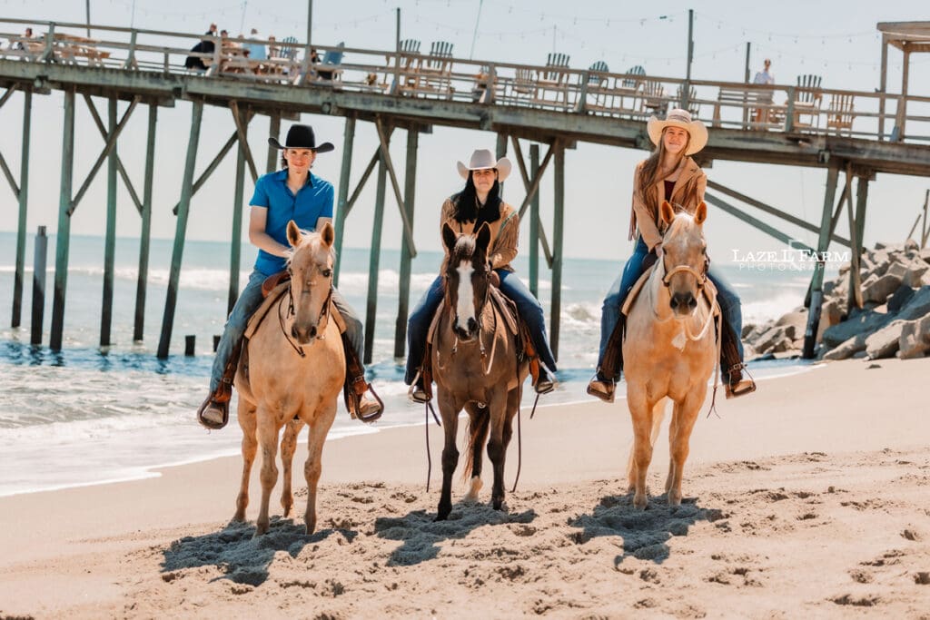 Couple riding horses on the beach