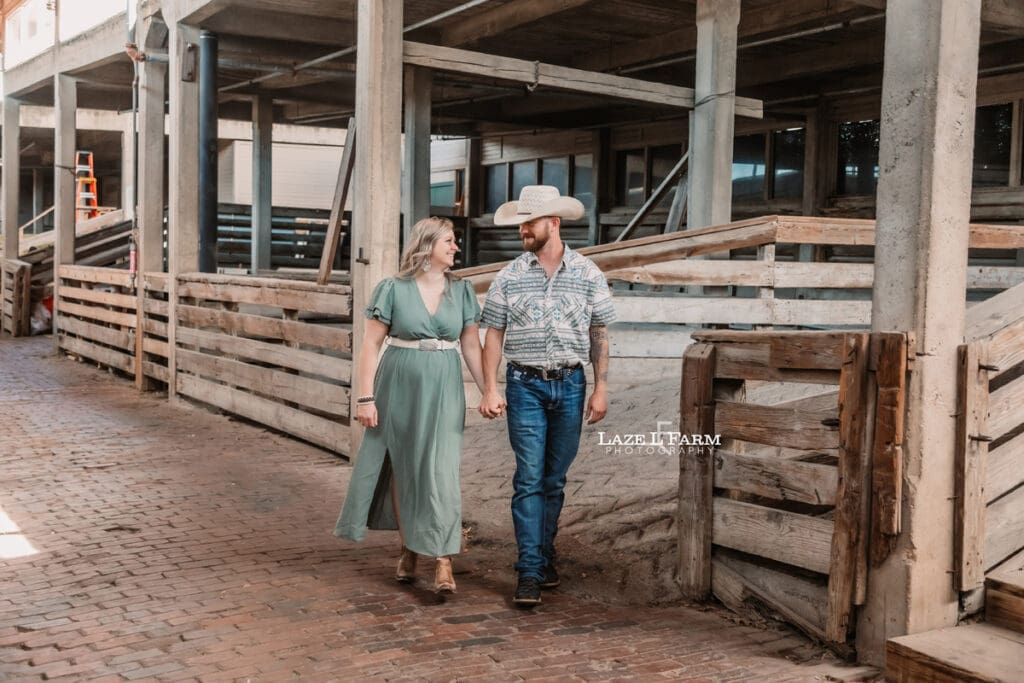 couple holding hands in the stockyards