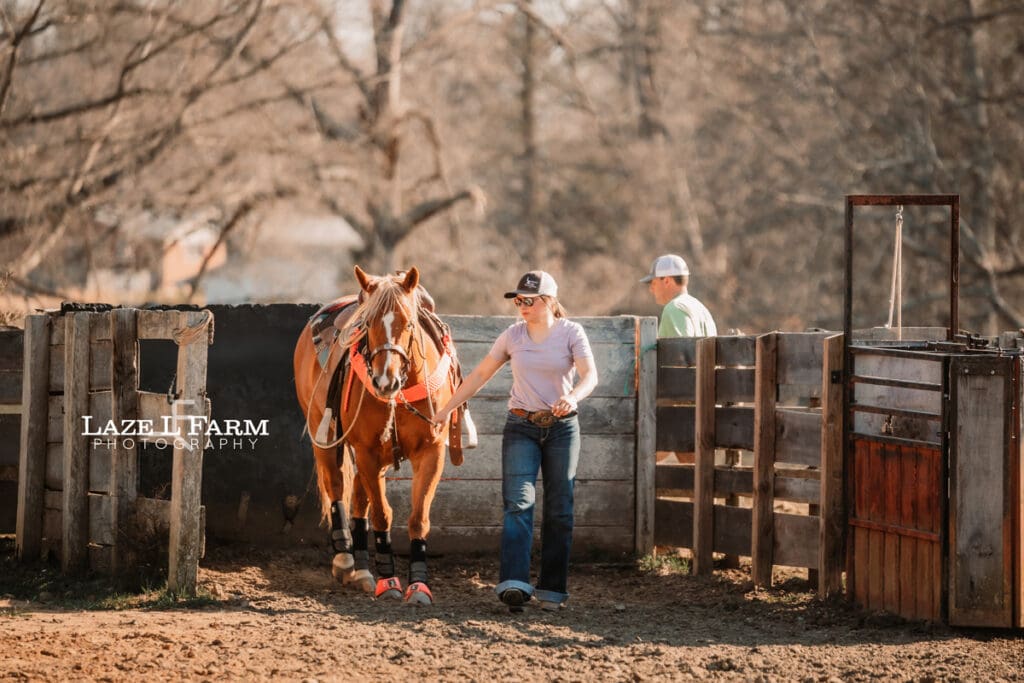 cowgirl walking her horse