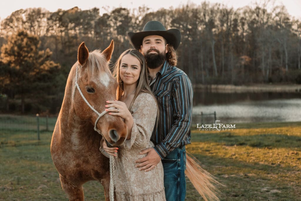 couple standing with horse