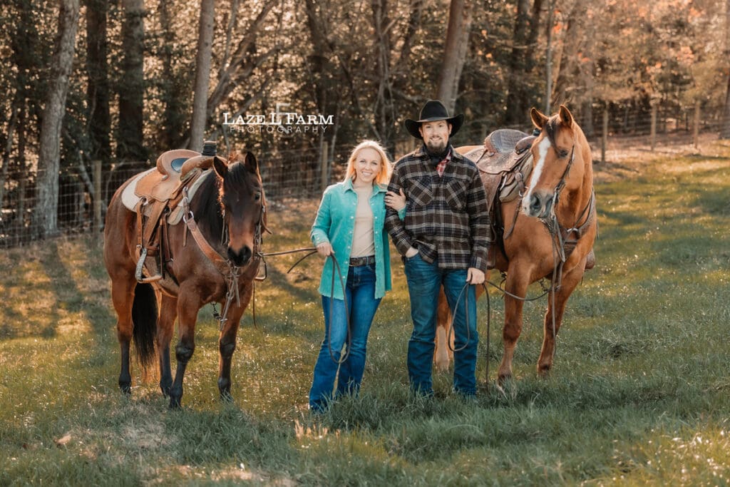 couple standing beside of each other with horses