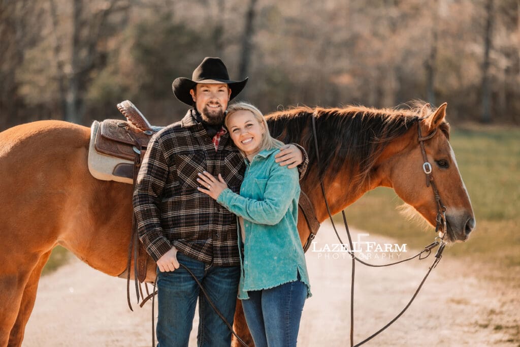 couple hugging in front of horse
