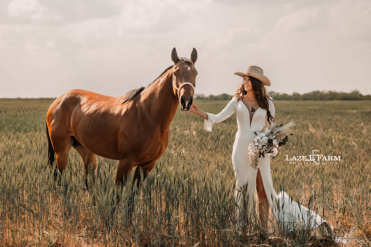 cowgirl bride holding her horse and flowers