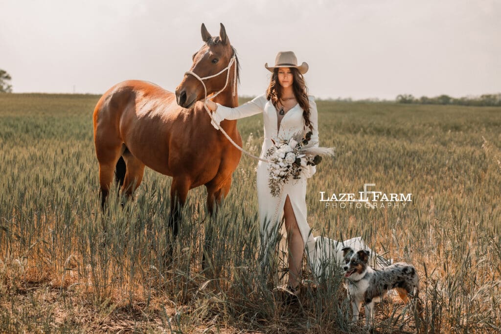 cowgirl bride holding her horse and flowers with her dog
