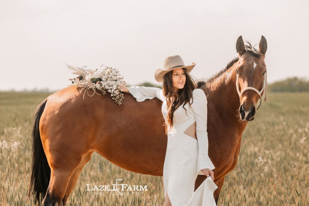 cowgirl bride with her horse and flowers