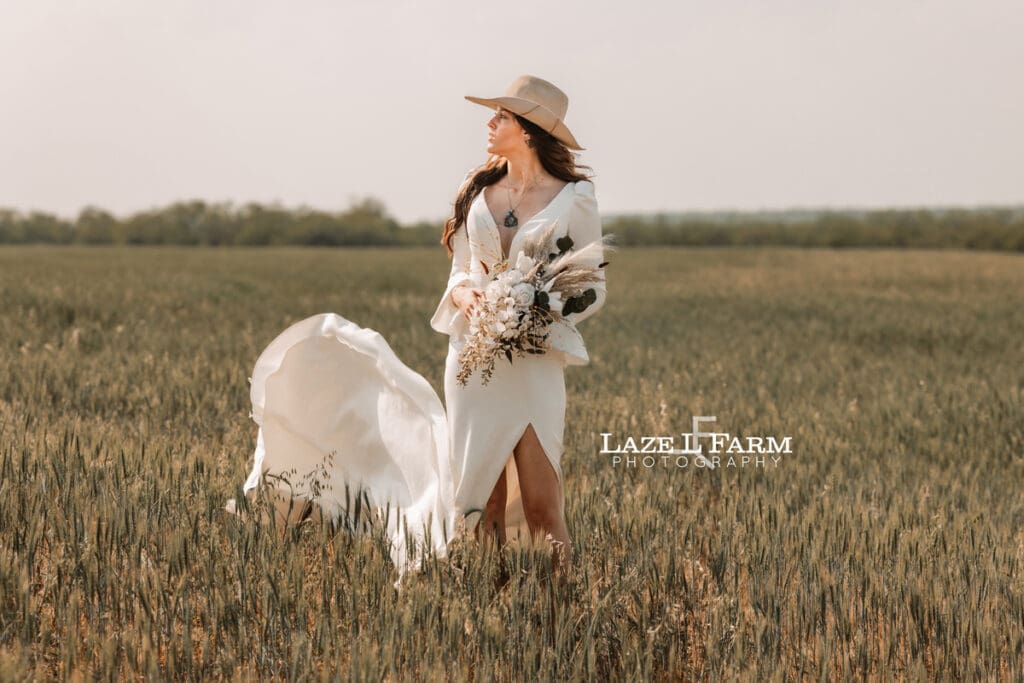 cowgirl bride with flowers in a wheat field
