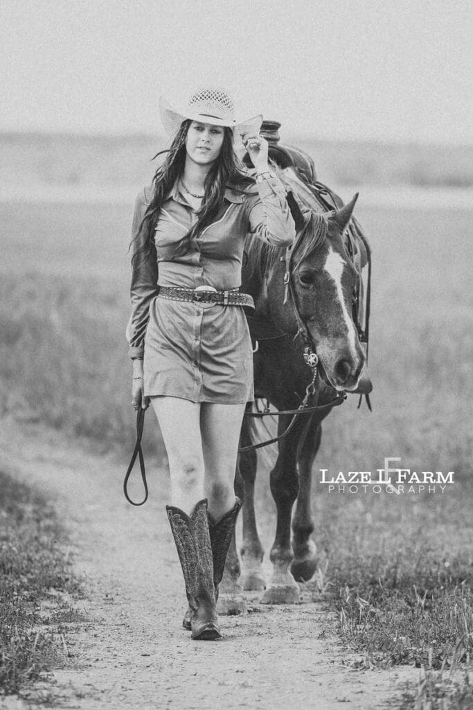 cowgirl walking towards the camera with her hrose