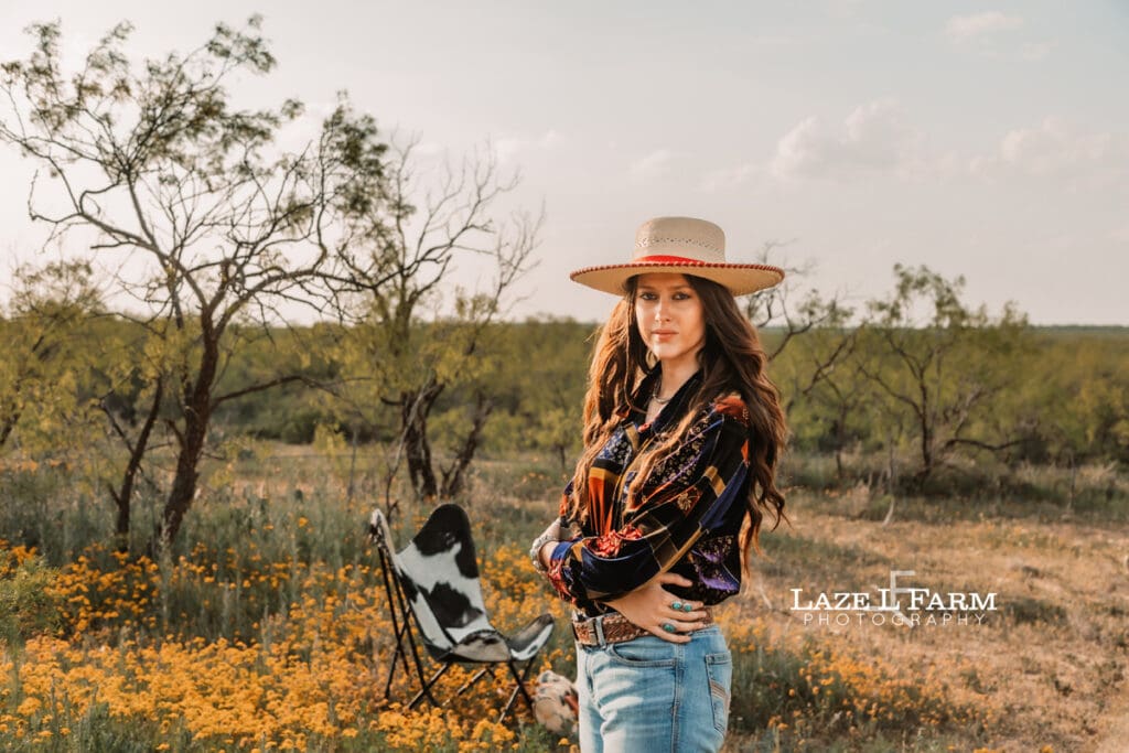 cowgirl standing in a flower field