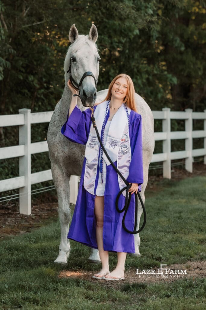 girl in cap and gown with horse