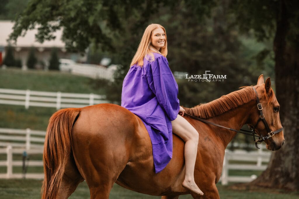 girl in cap and gown with her horse