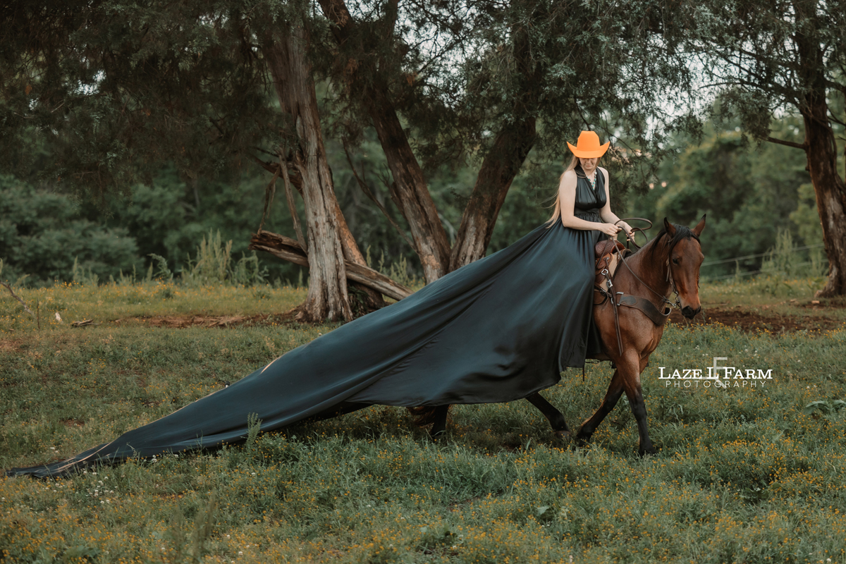 cowgirl riding her horse in a parachute dress