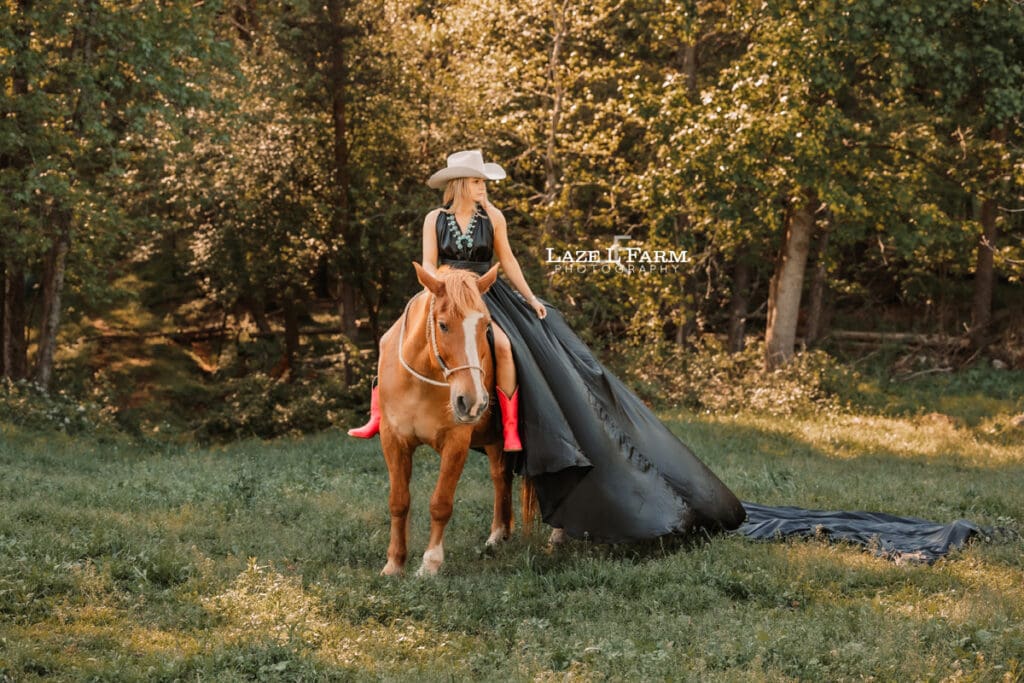 girl in a black parachute dress on the back of a horse