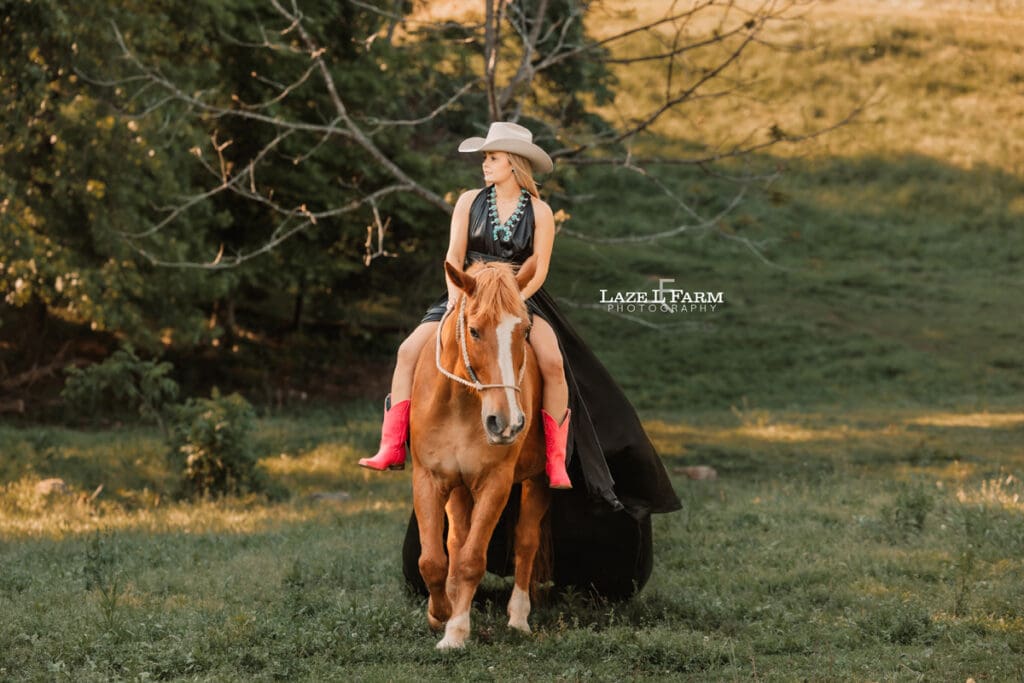 girl in a black parachute dress on the back of a horse