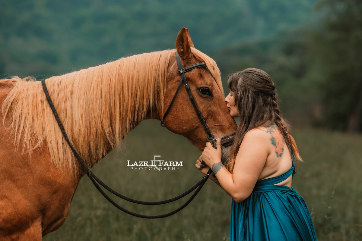 girl kissing her horse on the nose