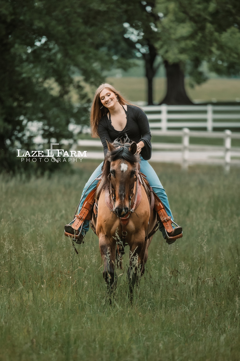cowgirl riding her horse