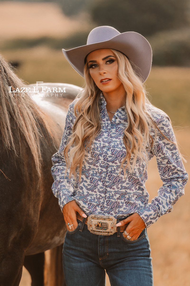 cowgirl and her horse standing in a field