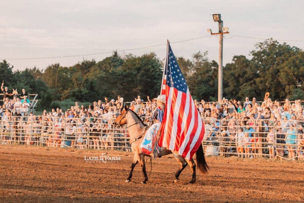 Grand Entry of the American Flag at the Cleveland Rodeo while Laze L Farm Photography takes pictures