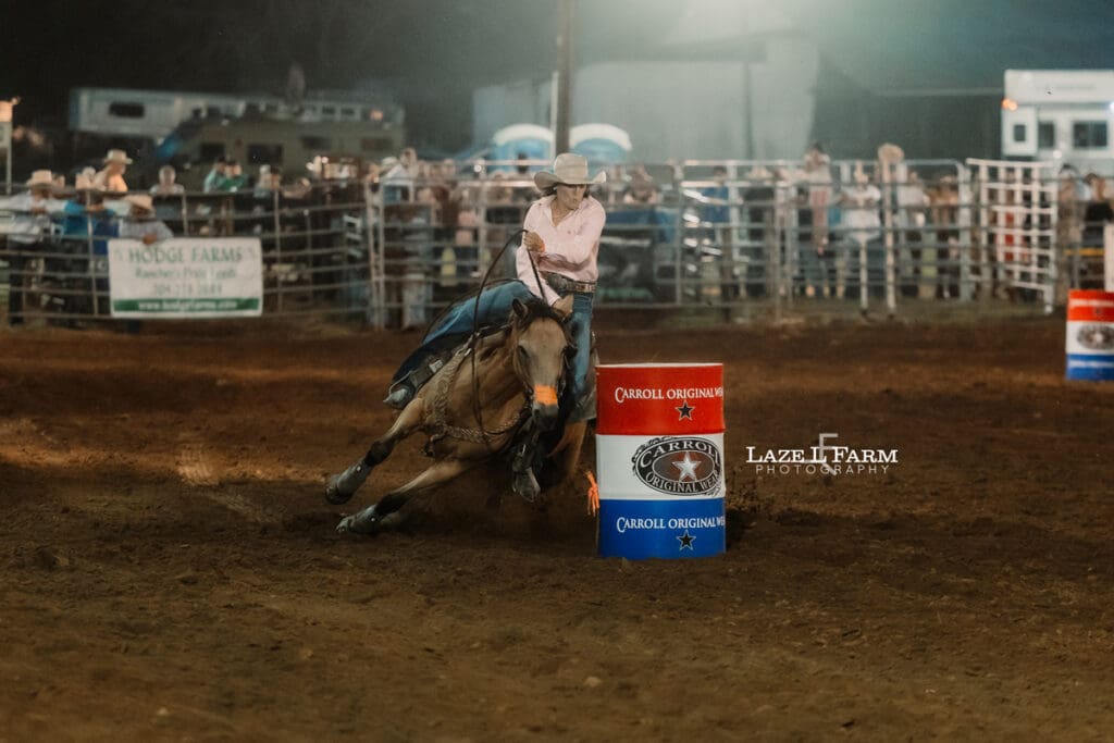 Cowgirl running barrels at the Cleveland Rodeo while Laze L Farm Photography takes pictures