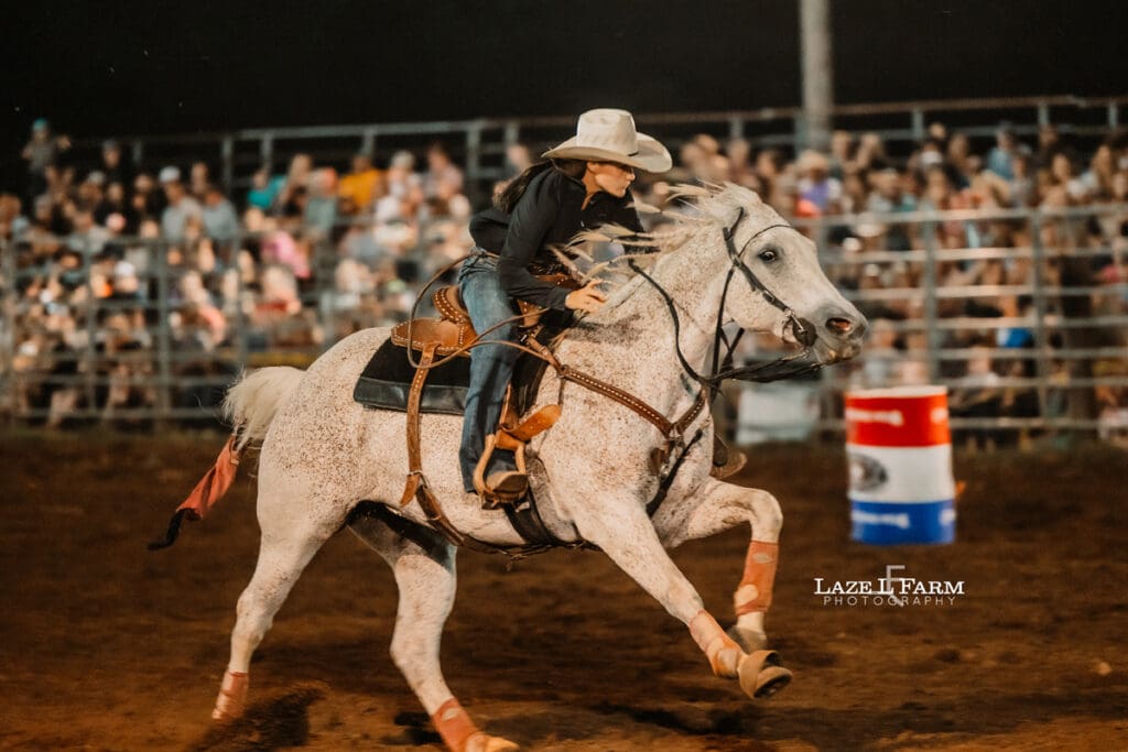 Cowgirl running barrels at the Cleveland Rodeo while Laze L Farm Photography takes pictures