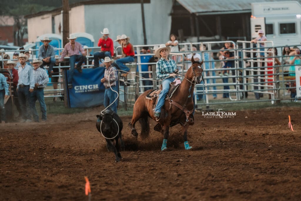 Cowgirl doing breakaway roping at the Cleveland Rodeo while Laze L Farm Photography takes pictures