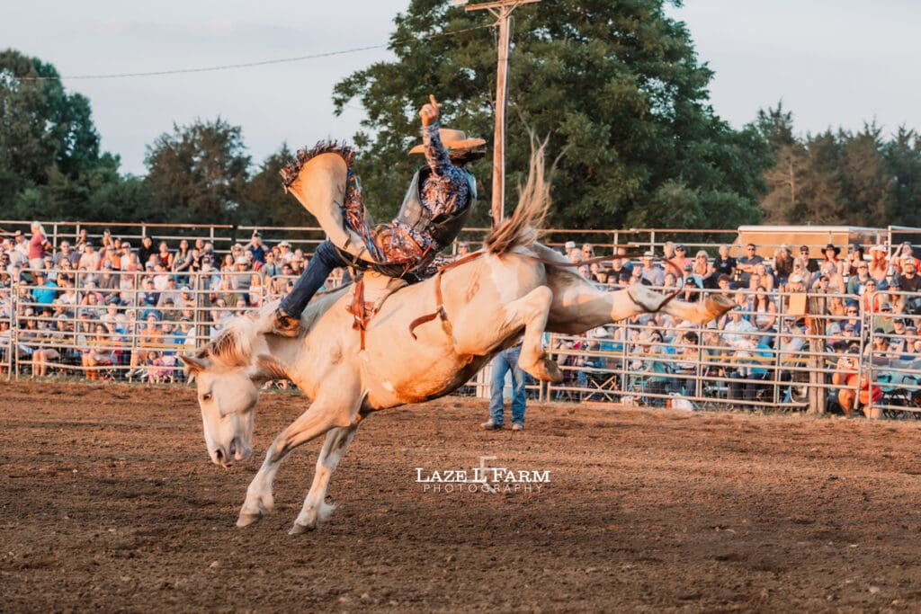 Cowboy during the broncs at the Cleveland Rodeo with pictures by Laze L Farm Photography