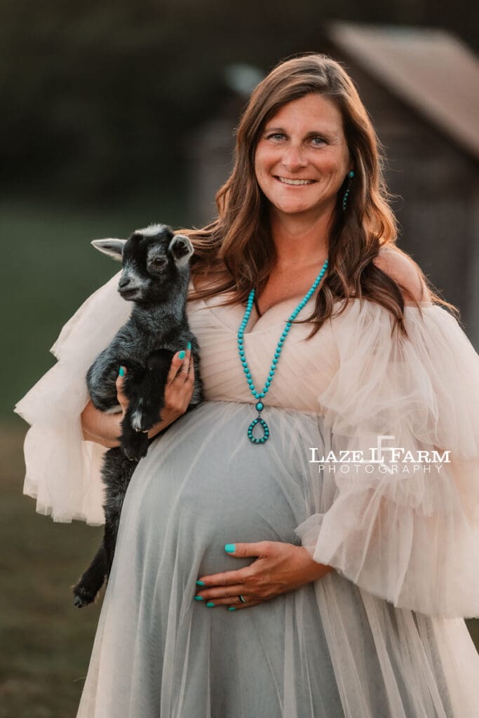 A girl during her maternity session with her goat during a photoshoot with Laze L Farm Photography