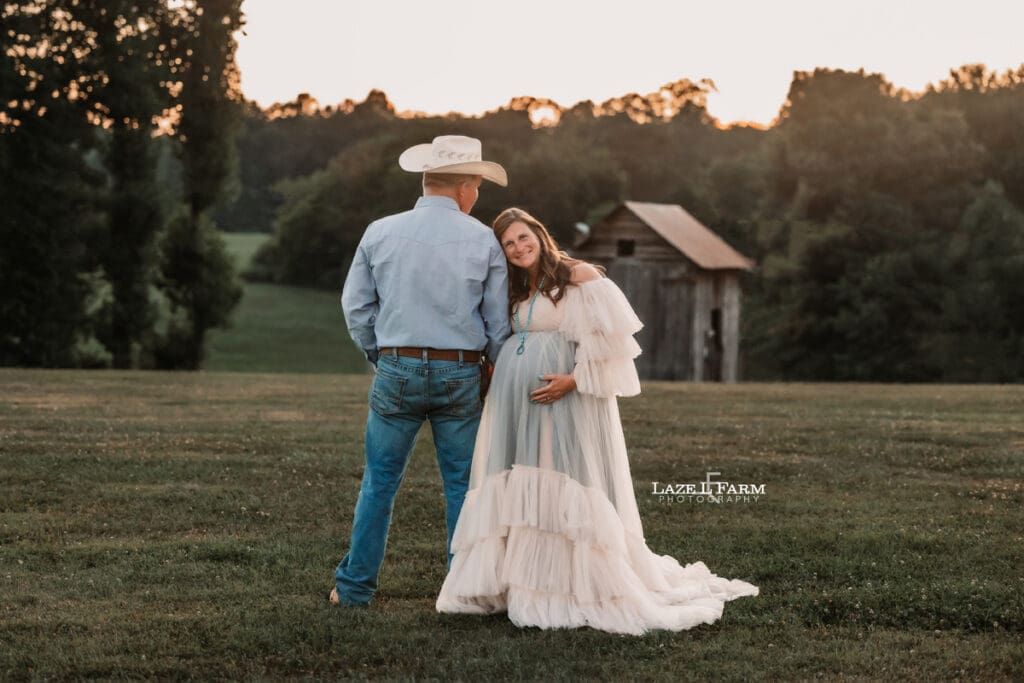 A girl and her husband during their maternity session with Laze L Farm Photography