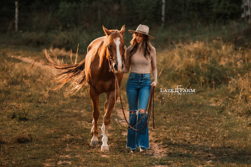 cowgirl standing beside a horse during an equine photoshoot with Laze L Farm Photography