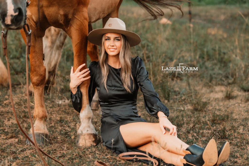 cowgirl sitting in front of the horse during an equine photoshoot with Laze L Farm Photography